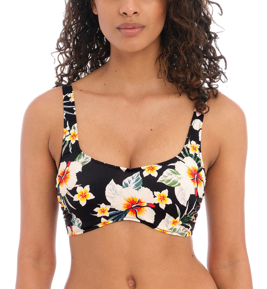 Woman wearing a floral bikini top on a white background