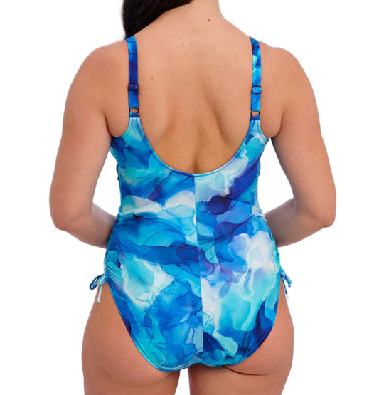 Woman wearing a blue and white patterned swimsuit on a white background