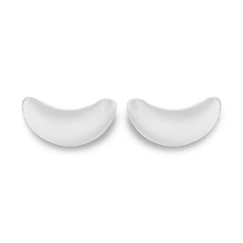 Two white ceramic crescent moon-shaped dishes on a white background