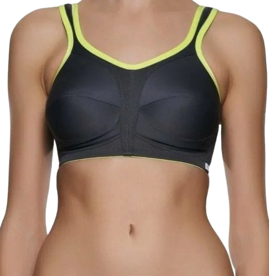 Black sports bra with green trim on a plain background
