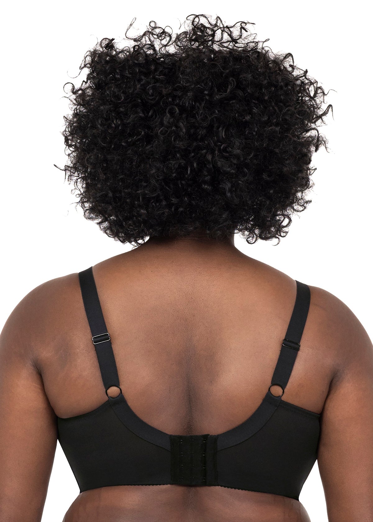 Black bra worn by a person with curly hair on a white background