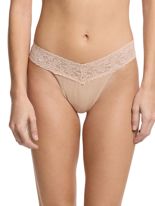 Lace thong worn by a person on a white background