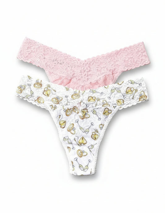White underwear with gold heart patterns and pink lace trim on a white background