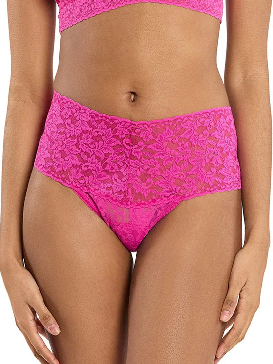 Pink lace underwear on a model against a white background