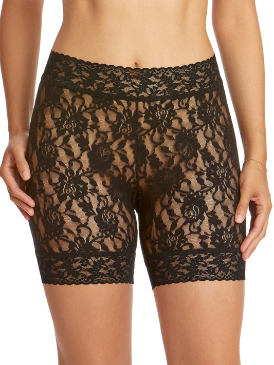 Black lace shorts worn by a person on a white background