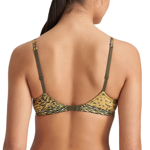 Woman wearing a leopard print bikini top with green straps on a white background