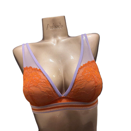 Orange bra with purple straps on a mannequin against a dark background