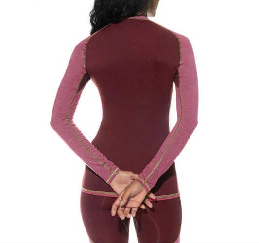 Maroon athletic outfit with pink mesh panels on a white background