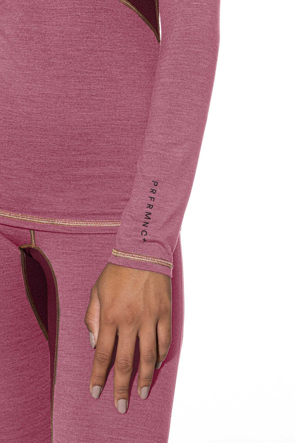 Close-up of a pink athletic outfit with 'Performance' branding on the sleeve.