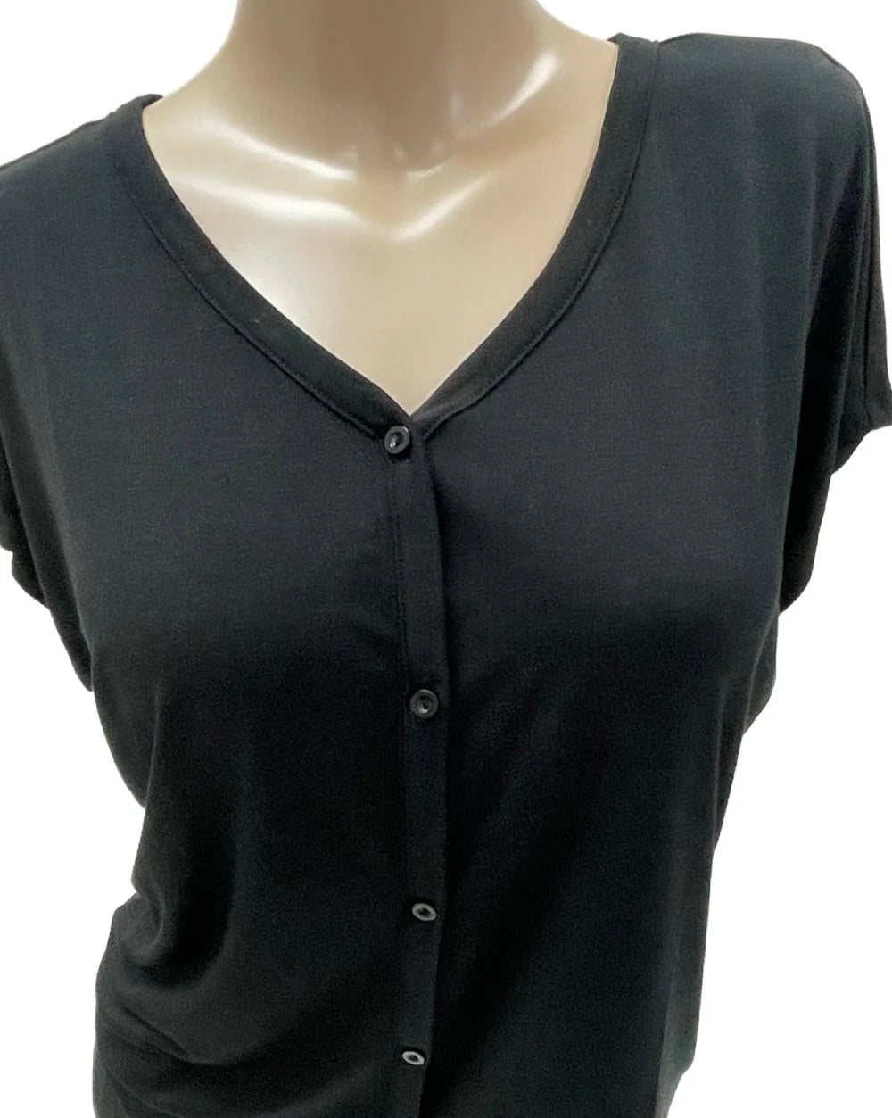 Black button-up shirt on a mannequin with a white background