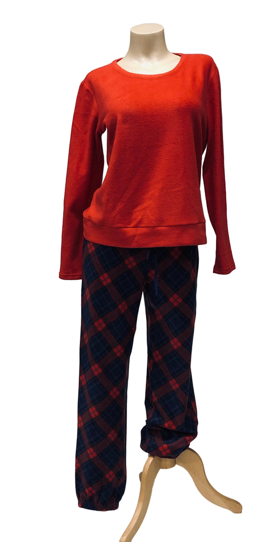 Red top and plaid pants on a mannequin against a white background