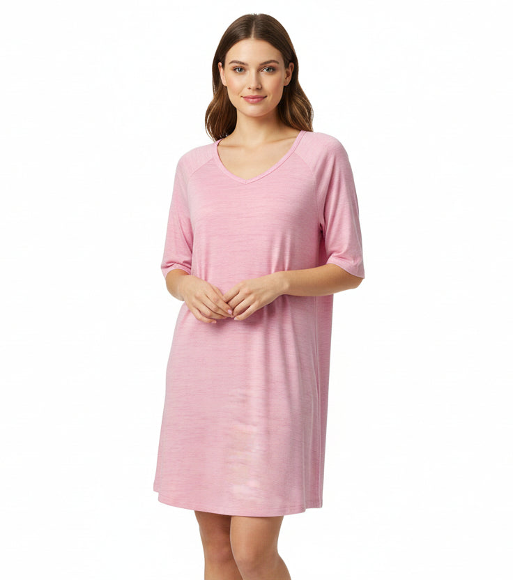 Pink nightgown on a wooden mannequin against a white background