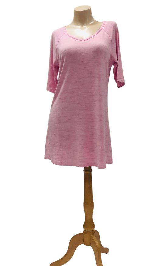 Pink nightgown on a wooden mannequin against a white background