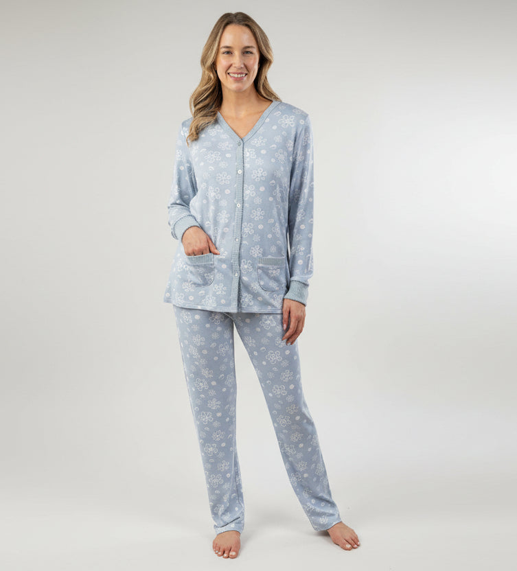 Woman wearing a light blue pajama set with a white background