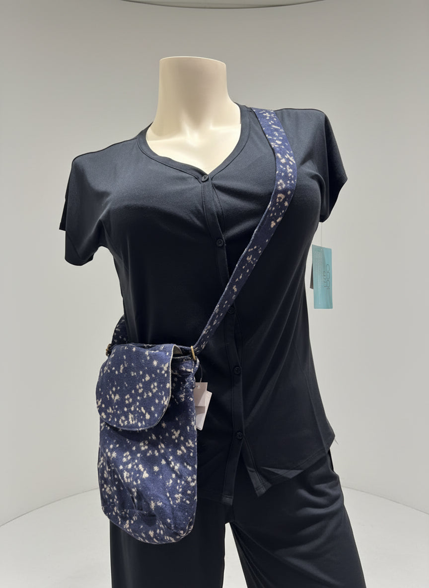 Mannequin wearing a black outfit with a navy blue crossbody bag on a plain background