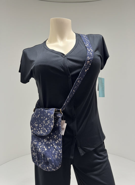 Mannequin wearing a black outfit with a navy blue crossbody bag on a plain background