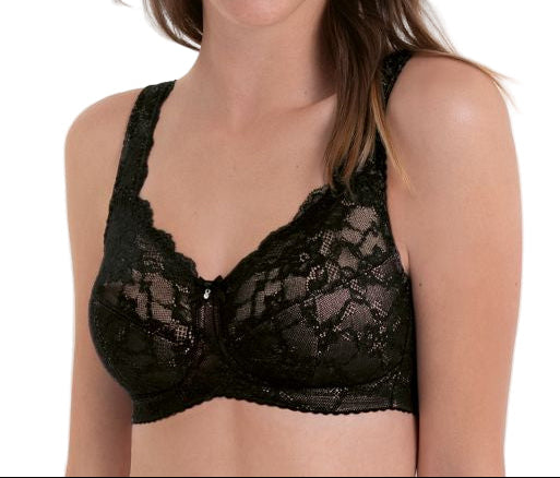 Woman wearing a black lace bralette on a white background