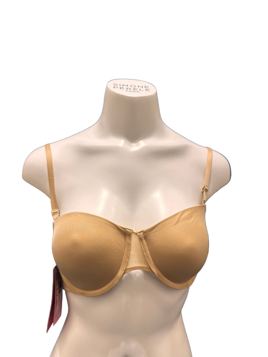 Mannequin bust wearing a beige bra on a dark blue fabric background