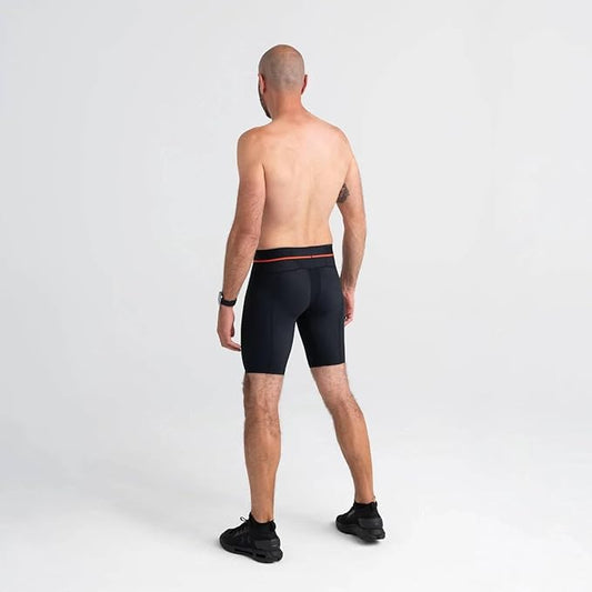 Man wearing black briefs on a light gray background