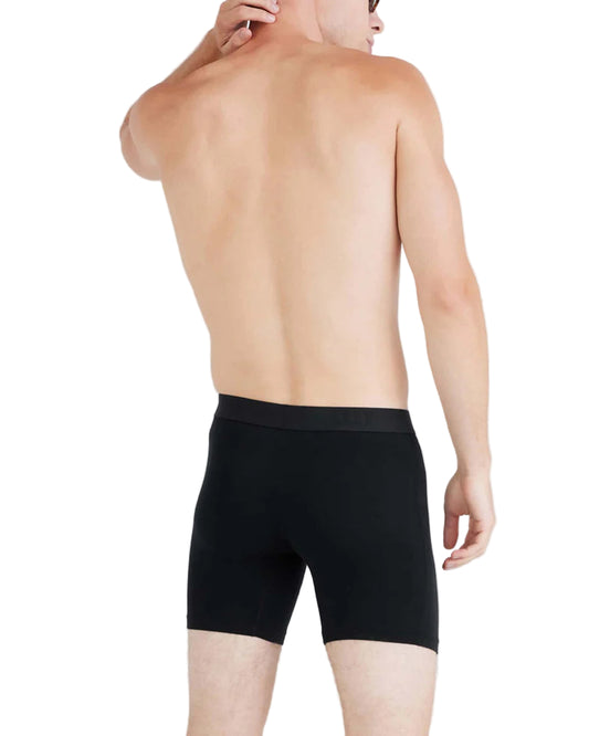 Person wearing black underwear on a plain background