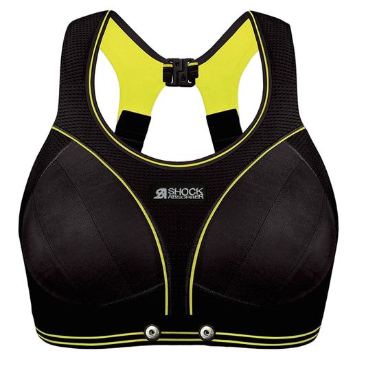 Black sports bra with yellow accents and 'Shock Absorber' branding on a white background
