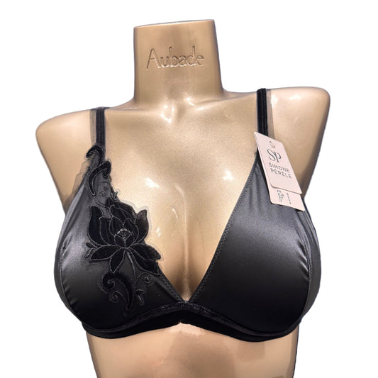 Black underwear on a beige mannequin with floral design 