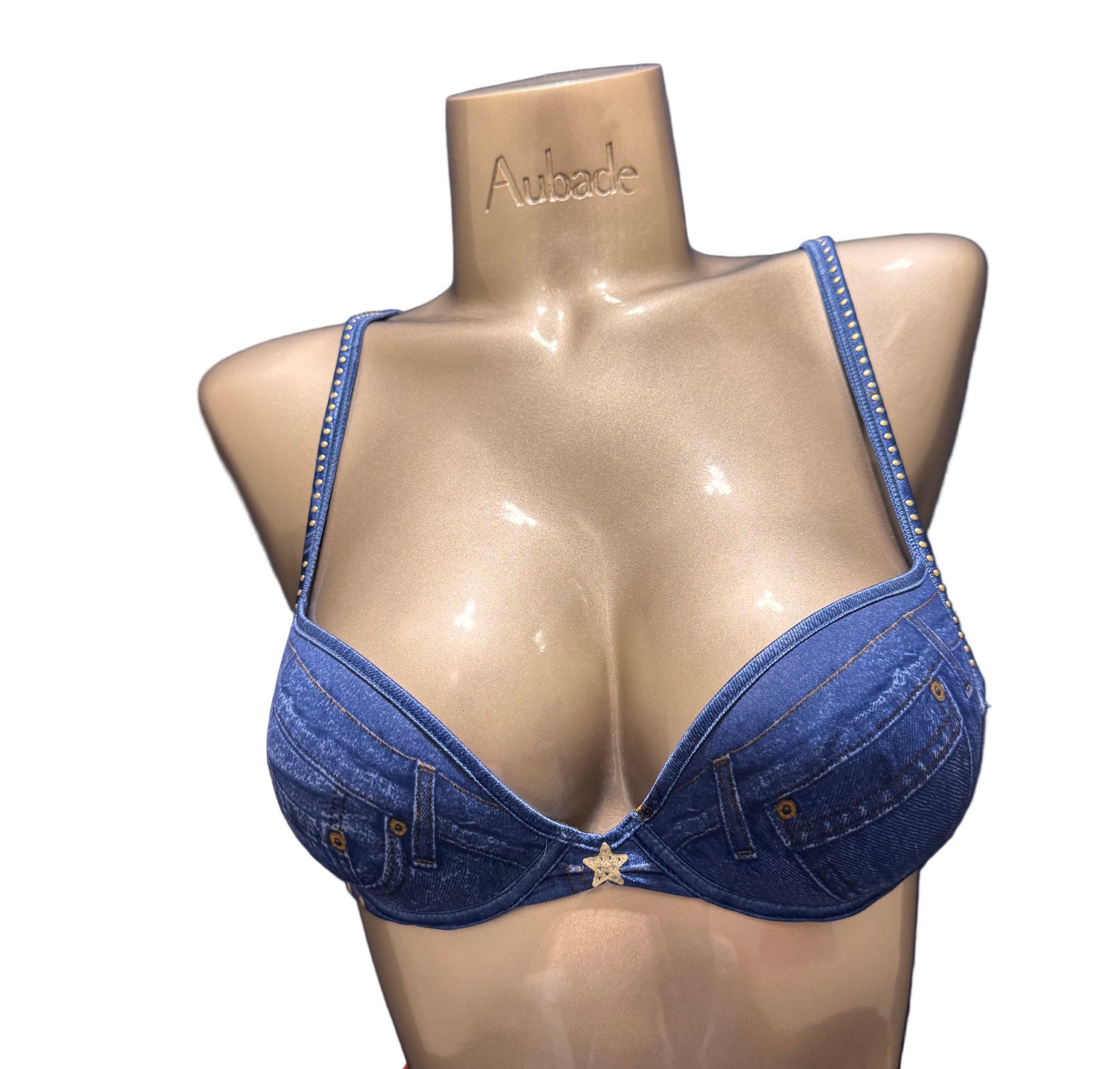 Blue denim bra on a mannequin bust against a dark background