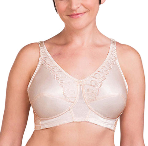 Woman wearing a beige bra against a plain background