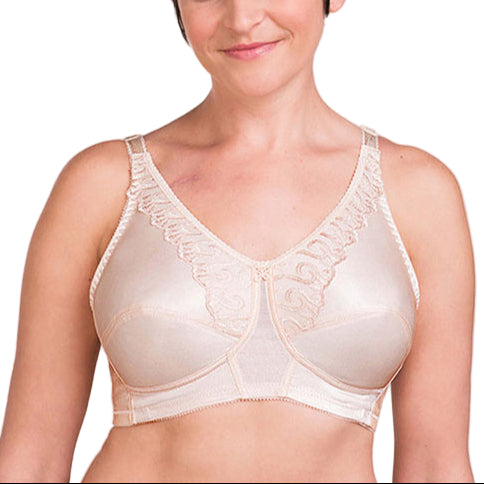 Woman wearing a beige bra against a plain background