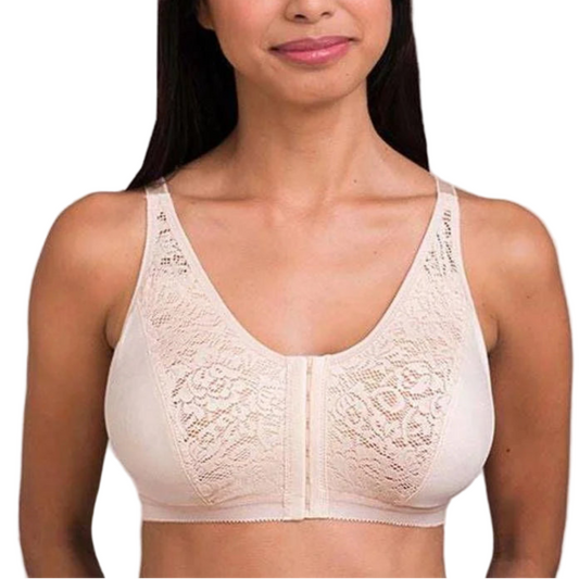 Woman wearing a beige lace bralette against a plain background