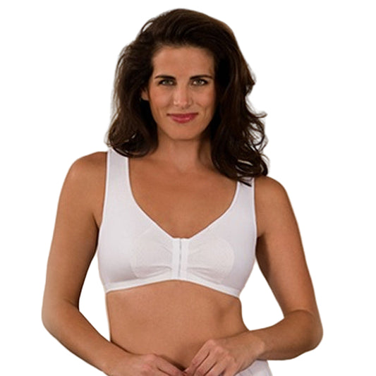 Woman wearing a white bra against a beige background