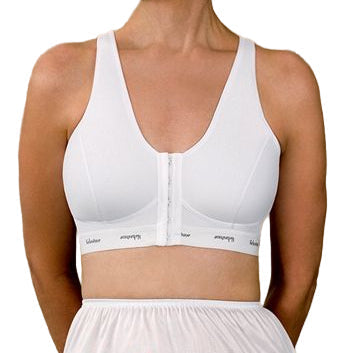 Woman wearing a white sports bra and underwear set against a beige background