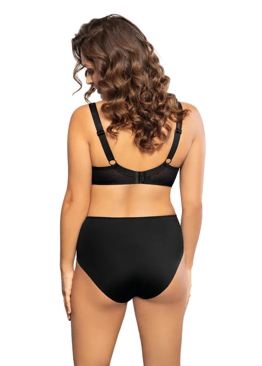 Woman wearing a black bra and high-waisted underwear on a white background