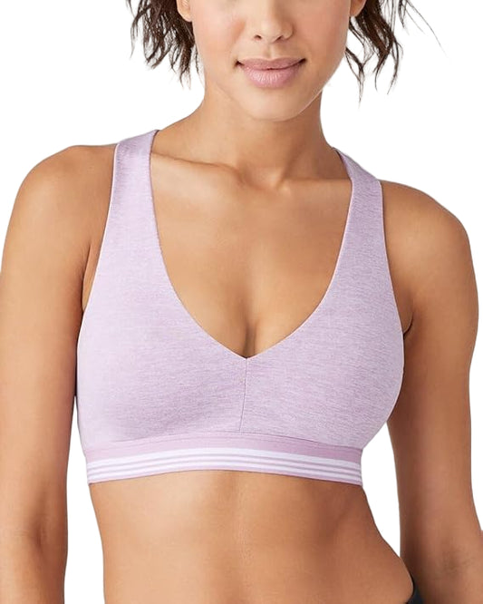 Woman wearing a light purple sports bra on a white background