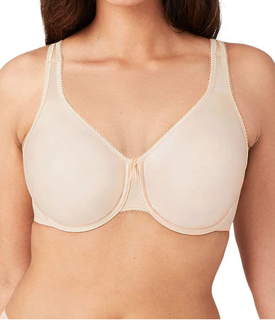 Woman wearing a beige bra on a white background