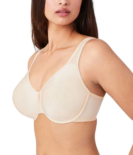 Woman wearing a beige bra on a white background