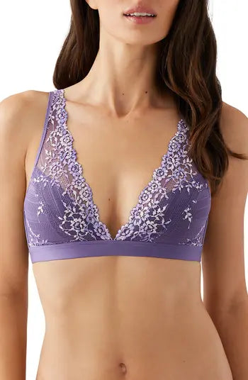 Purple lace bra worn by a model on a white background