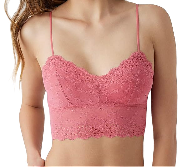 Woman wearing a pink lace bralette against a white background