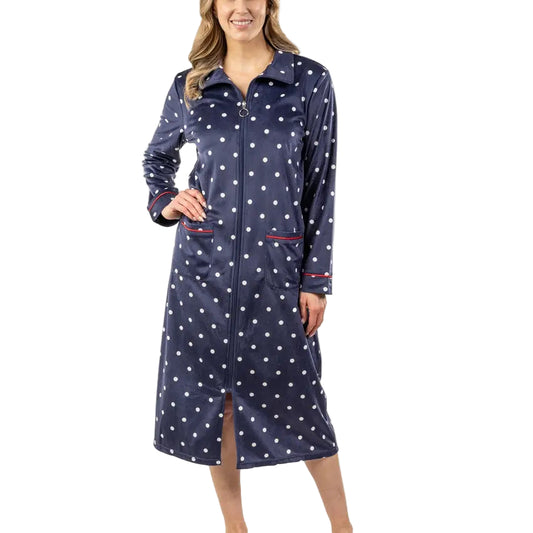 Woman wearing a navy robe with white polka dots on a white background