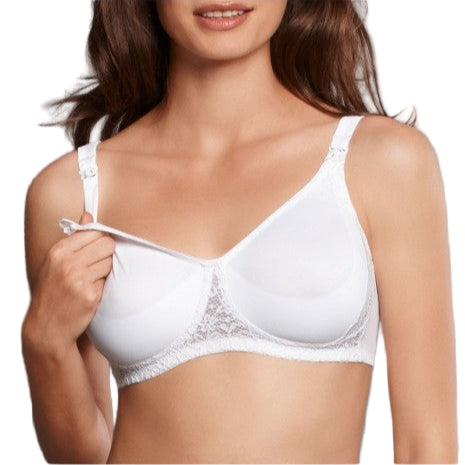 Woman wearing a white bra against a gray background