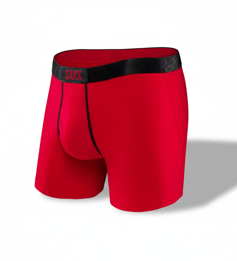 Red SAXX boxer briefs with black waistband on a white background