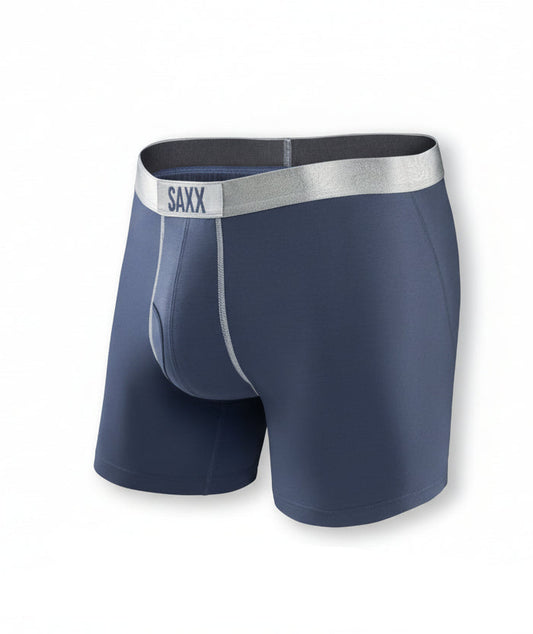 Navy blue SAXX boxer briefs with a silver waistband on a white background